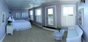 The Sunrise Suite -- Our largest guest suite is also the Grey Havens Inn's signature guest accommodation. Guests in the Sunrise Suite enjoy a king-size bed, a private bath and an incredible view of the ocean and coastline through three large windows and a French door leading to a private balcony.
