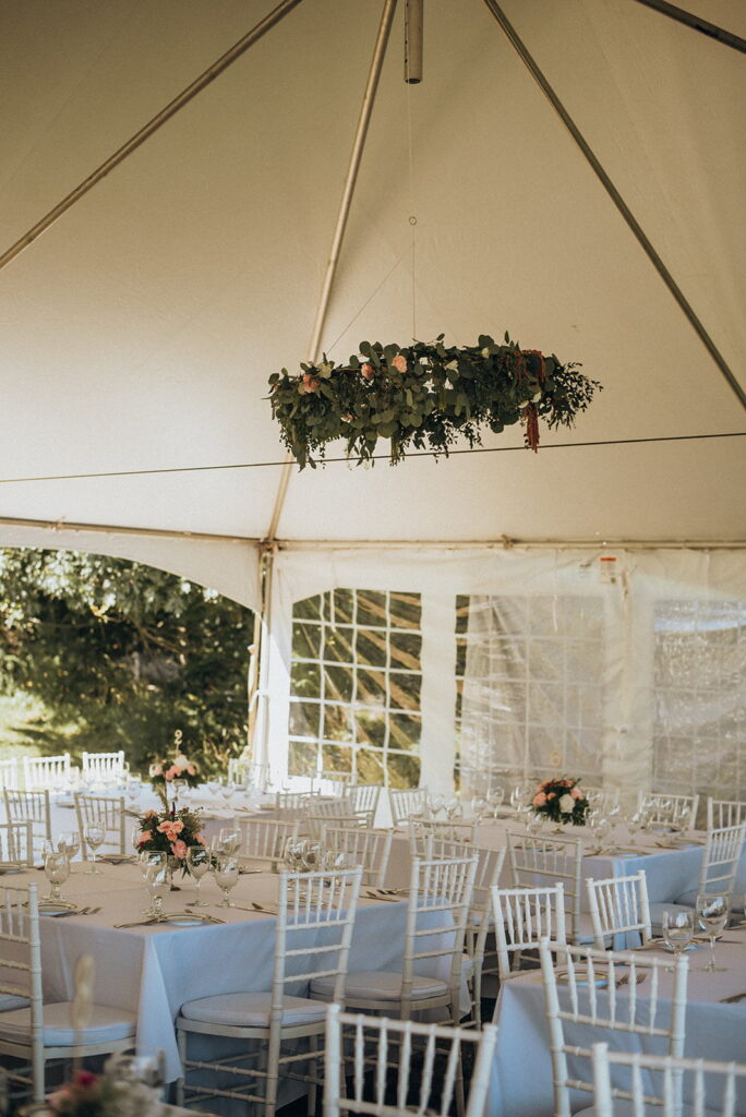 tables set under tent for reception