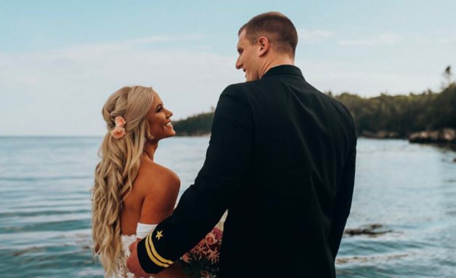 man and woman smiling at each other on wedding day