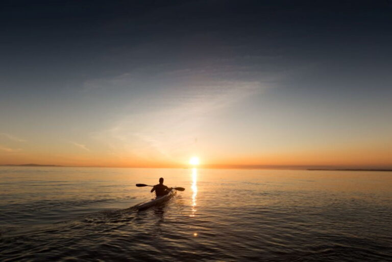 person paddling on ocean