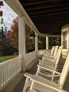 The porch in fall with rocking chairs
