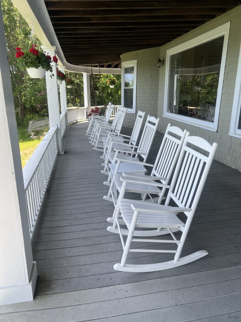 Row of rocking chairs on the porch of Grey Havens Inn